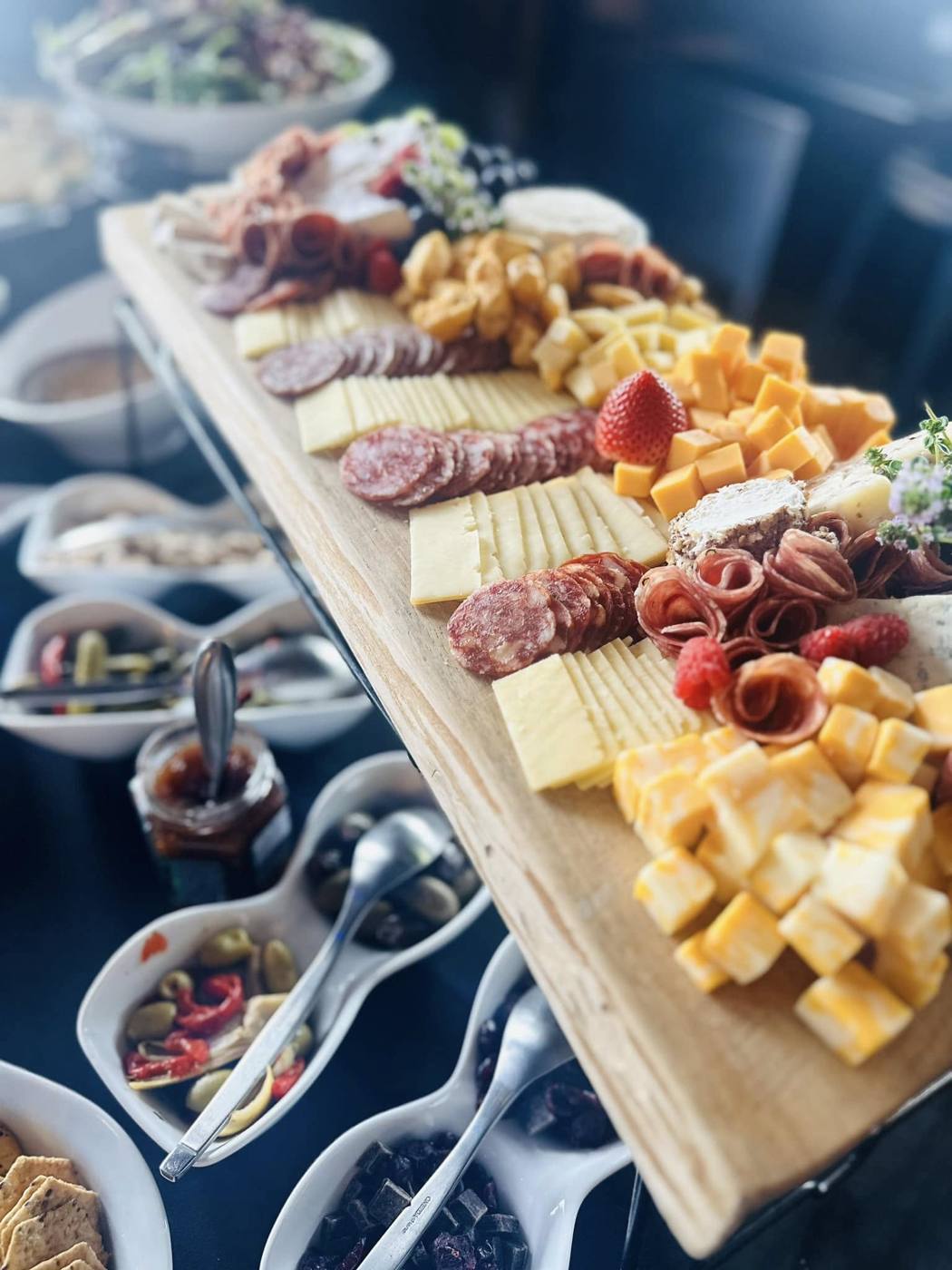 Grazing board with charcuterie, cheeses and berries
